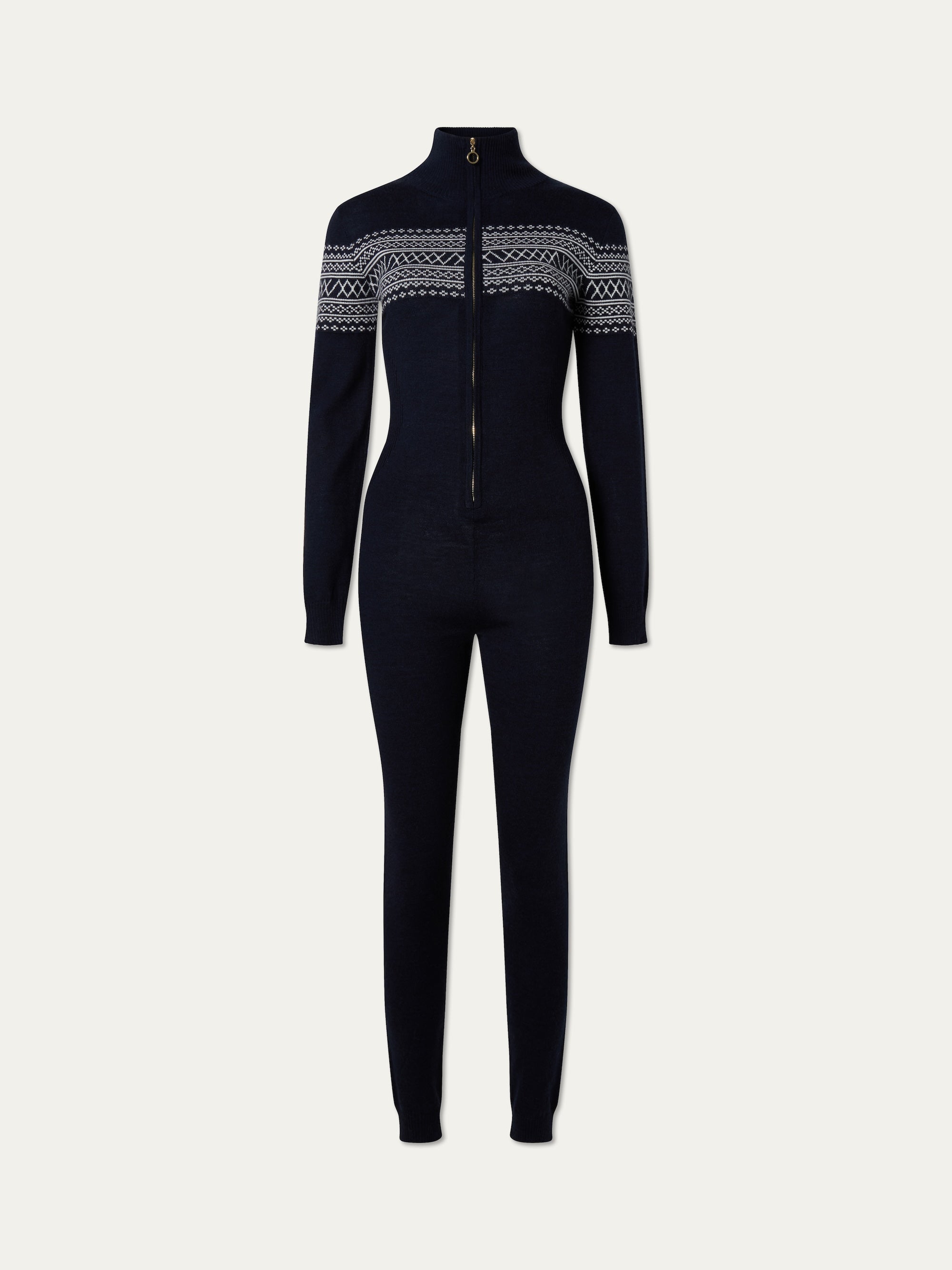 The We Norwegians Signature Jumpsuit Women features a navy blue, long-sleeve, full-length design in washable merino yarn, with a zip-up front and white Setesdal pattern across the chest and upper arms.