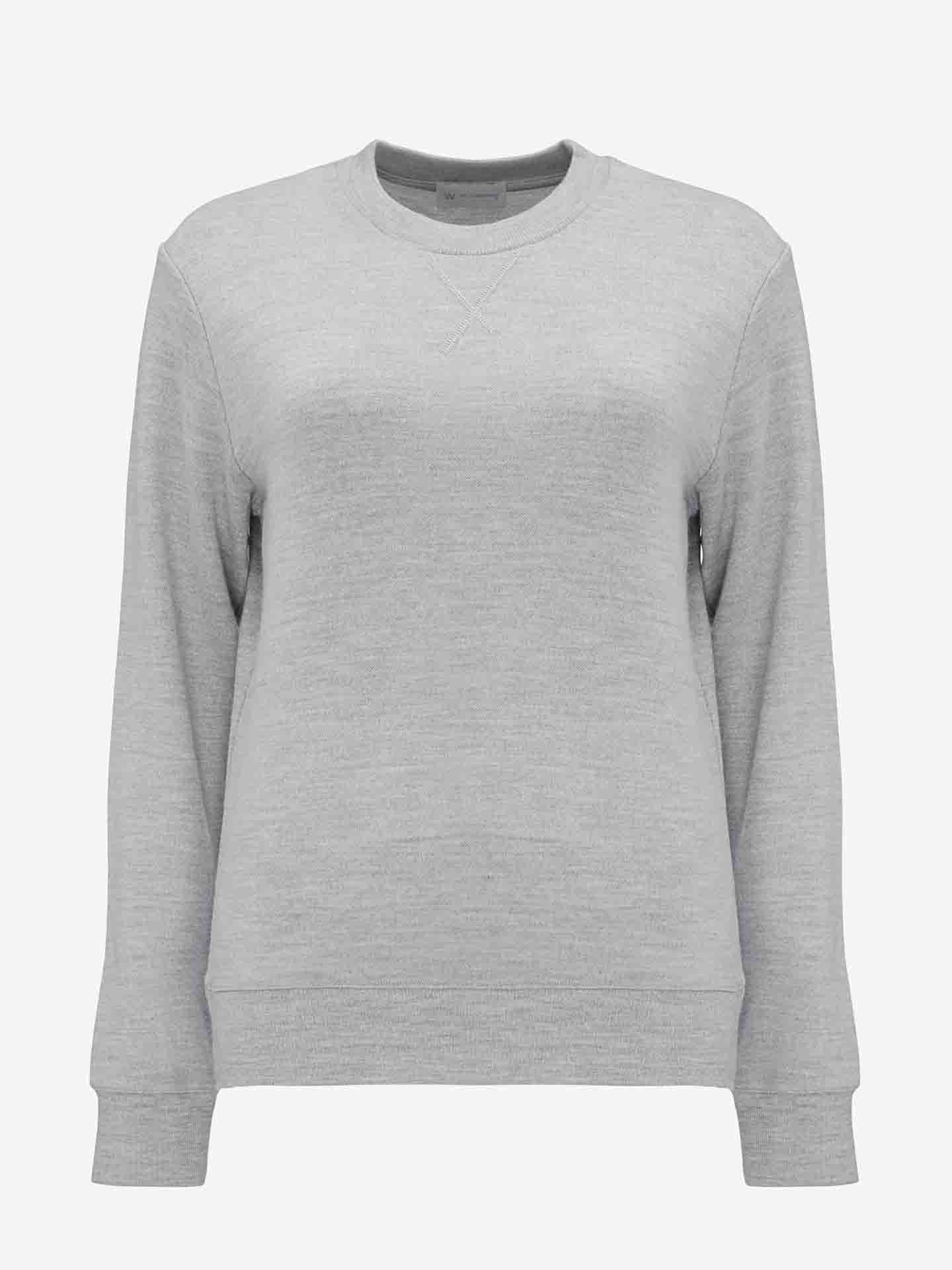 A plain, light gray Tind Crewneck sweatshirt with long sleeves by We Norwegians is shown against a white background. Made from Merino wool, it features a subtle V-stitch detail below the neckline. No other designs or logos are visible.