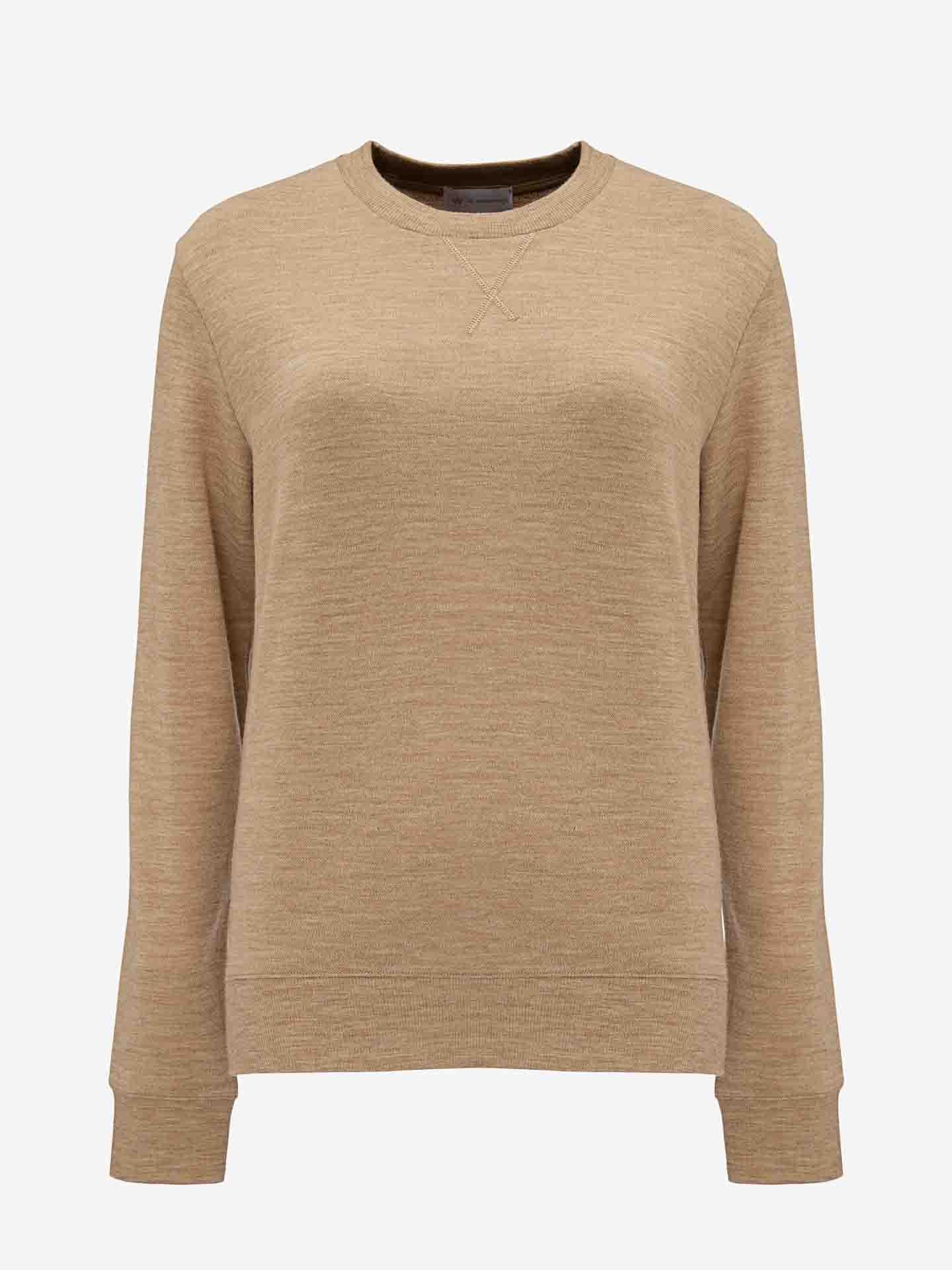 A camel-colored long-sleeve crewneck sweater displayed on a white background. Crafted from pure Merino wool, the We Norwegians Tind Crewneck Women Camel features a simple, minimalist design with ribbed cuffs and a small V-shaped stitch detail below the neckline, perfect for an elevated sportswear look.