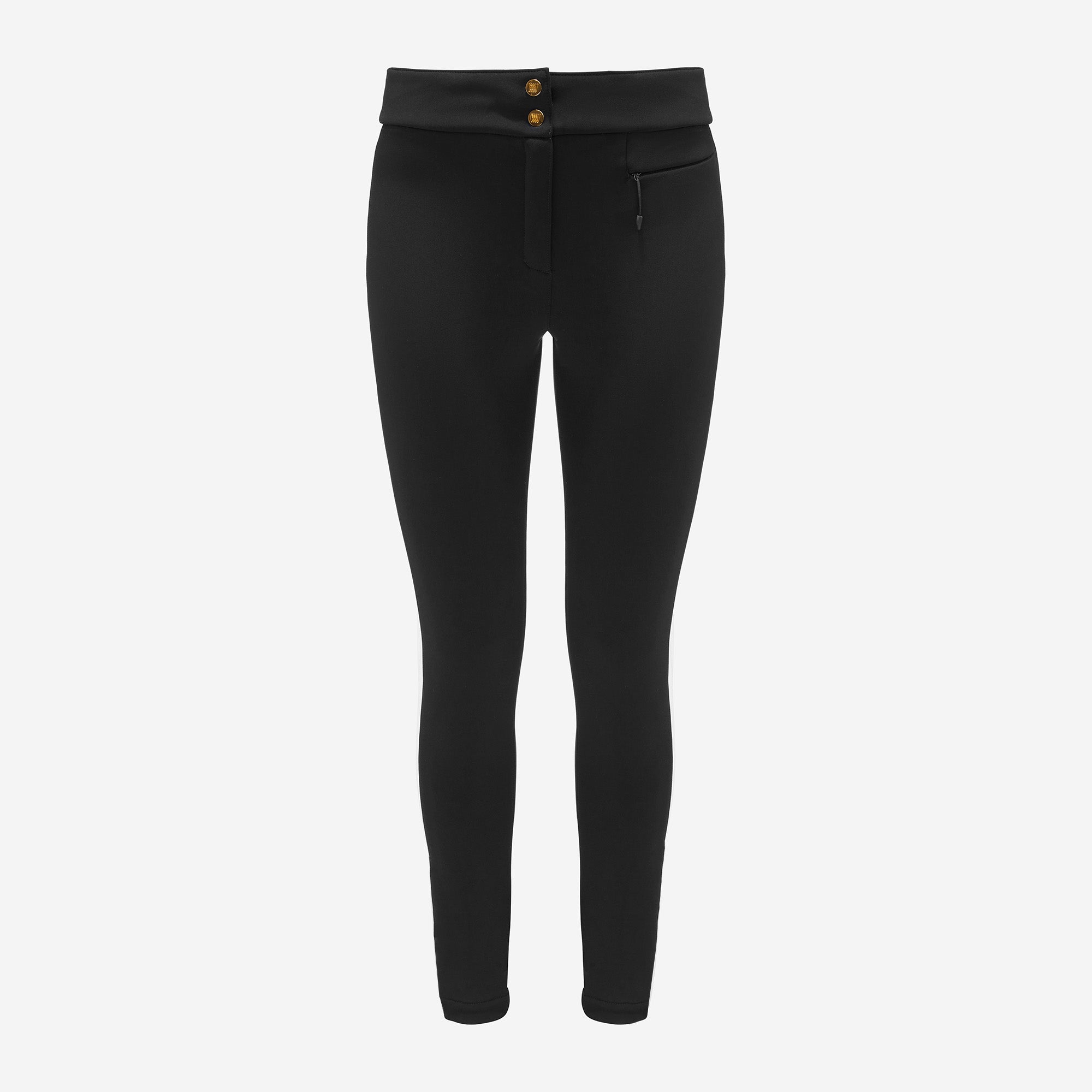 We Norwegians' Kvitfjell SlimLeg SkiPant Women features black high-waisted leggings with a front zipper and two gold waistband buttons, reminiscent of stirrup pants; made from form-fitting 4-way stretch fabric with a right-side visible front pocket set against a crisp white background.