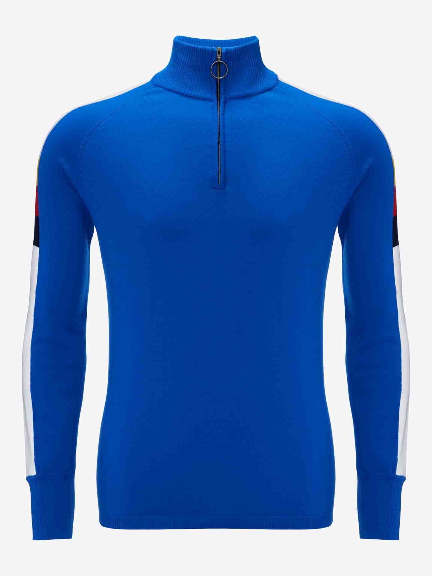 The Varden Zip Up Men by We Norwegians is a blue long-sleeve ski sweater with a half-zip front closure, featuring a ring pull zipper. Made in Italy from Merino wool, it boasts white and red stripes running along the length of each sleeve, from the shoulder to the wrist. The collar features a mock turtleneck style.