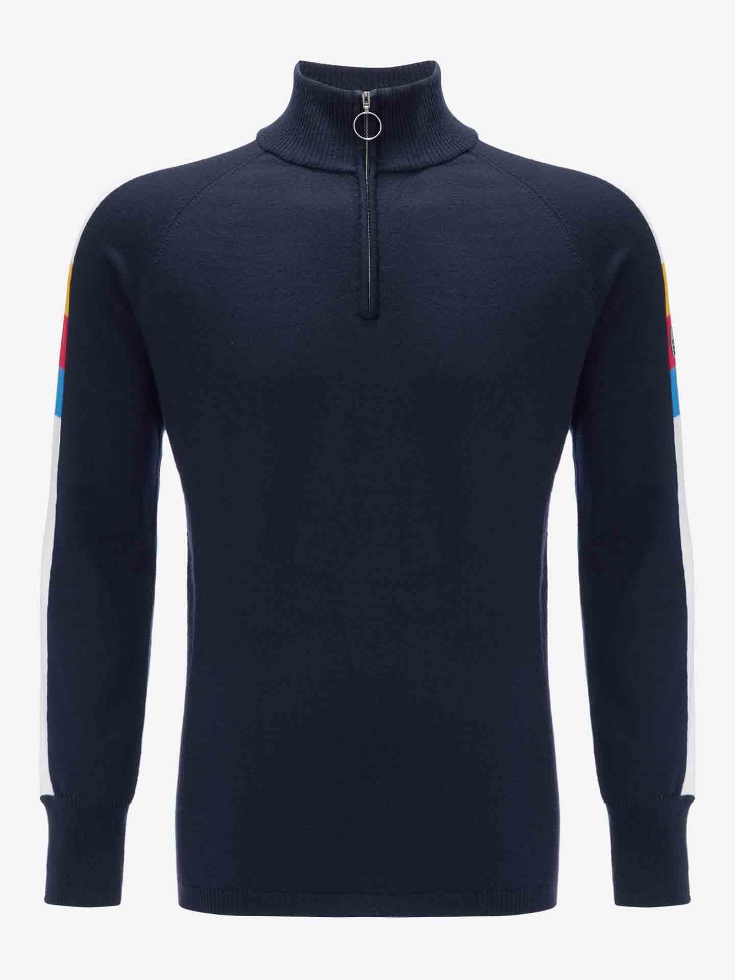 The Varden Zip Up Men by We Norwegians is a navy blue ski sweater featuring a high collar with a ring zipper. Made in Italy from premium Merino wool, it showcases multicolored stripes in blue, red, and white running from the shoulders to the cuffs. Designed with a slim fit, this sweater also includes ribbed textures on the cuffs and hem.