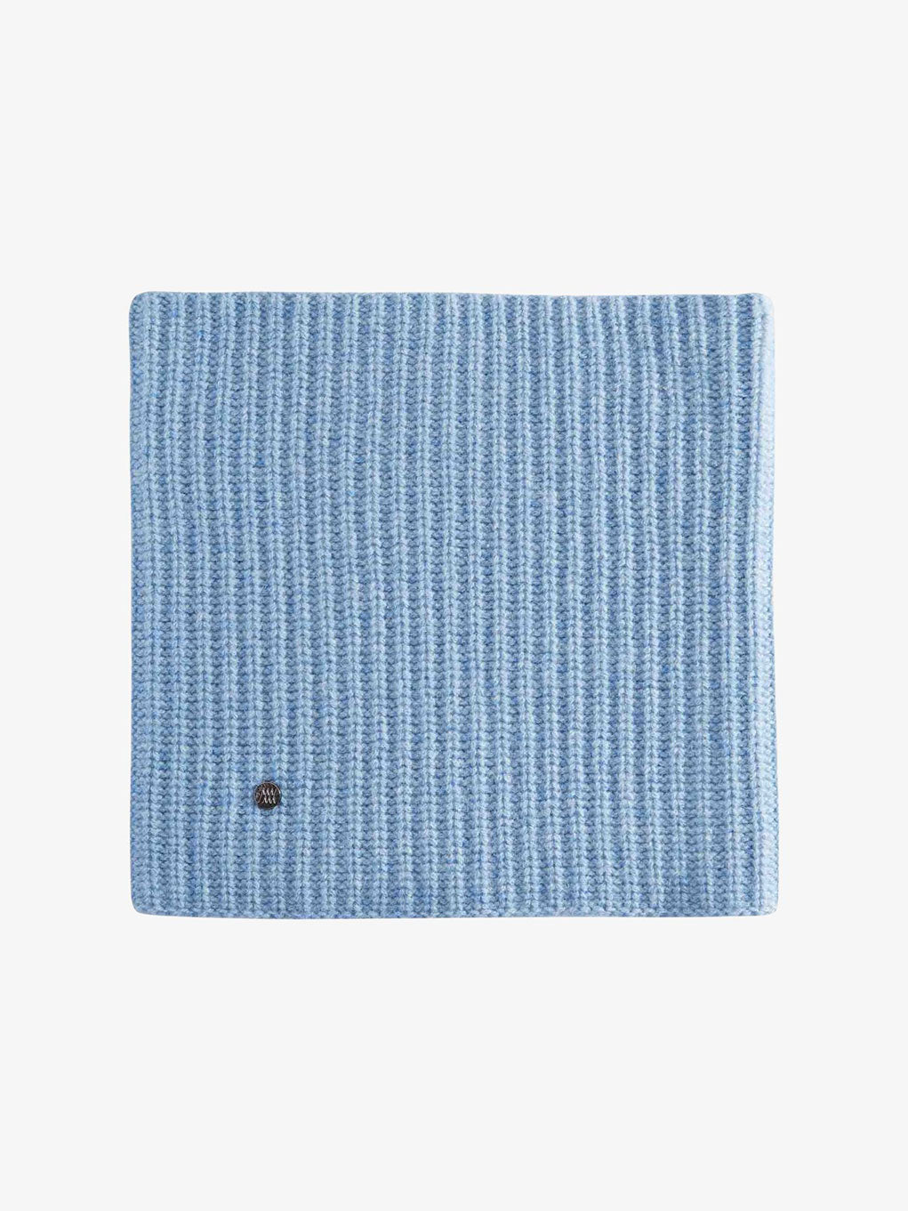 The Blefjell Cashmere Neckwarmer by We Norwegians, a folded blue ribbed knitwear scarf designed for warmth and comfort, features a small round metal emblem on the corner, all set against a plain white background.