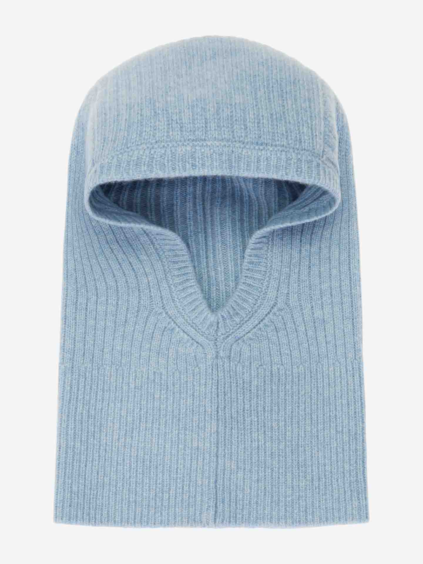 A Blefjell Balaclava Women in light blue by We Norwegians. This rib-knit balaclava offers a snug, form-fitting design with a facial opening and is crafted from soft, cozy cashmere material. Its texture and color provide a warm and comfortable appearance.