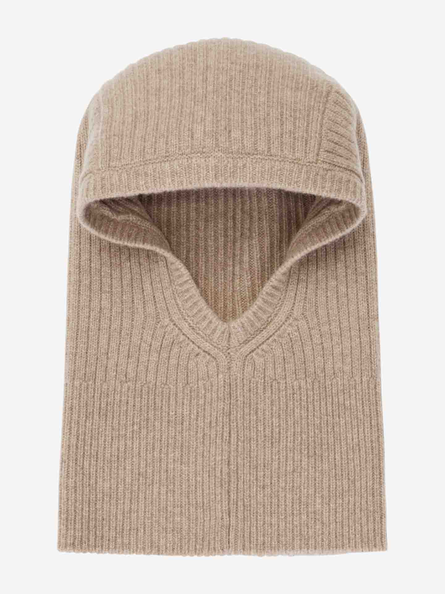 A beige Blefjell Balaclava Women by We Norwegians is displayed against a plain white background. Crafted from luxurious cashmere with a ribbed texture, it features a hood and an open front for the face, resembling a snug and warm winter accessory.