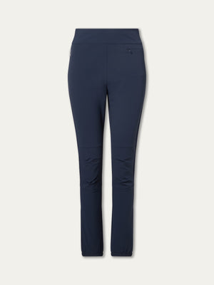 The We Norwegians Beito Pant Women in navy blue features a slim fit, high waistband, right hip zip pocket, and subtle knee seams—ideal for outdoor training—shown against a plain light background.