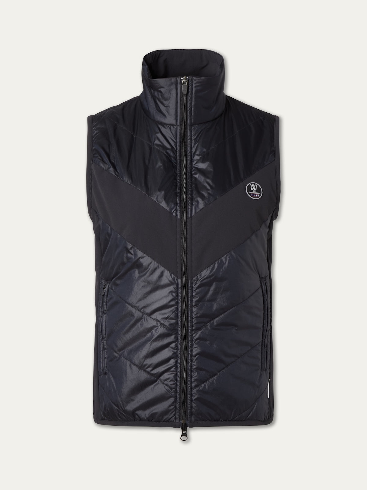 The We Norwegians Beito Vest Women is a black, sleeveless vest with a full front zipper, high collar, subtle chevron pattern, and small round logo on the left chest. Its shiny, slightly padded fabric features non-fluorinated DWR protection.