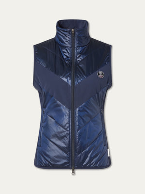 The We Norwegians Beito Vest Women is a sleeveless navy blue vest with a high collar, front zipper, diagonal quilting, shiny water-resistant fabric (non-fluorinated DWR), and a small round logo on the left chest.
