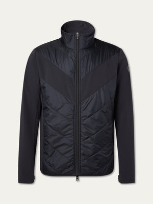 The We Norwegians Beito Jacket Men is a black, full-zip insulated winter jacket with a high collar, quilted chevron front, smooth sleeves and sides for comfort, and a subtle logo patch on the left upper sleeve.