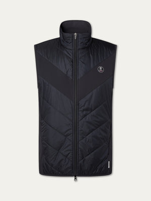 The Beito Vest Men by We Norwegians is a black, sleeveless vest with a high collar, front zipper, chevron stitching, and a circular logo on the left chest—ideal for performance layering on cooler days.