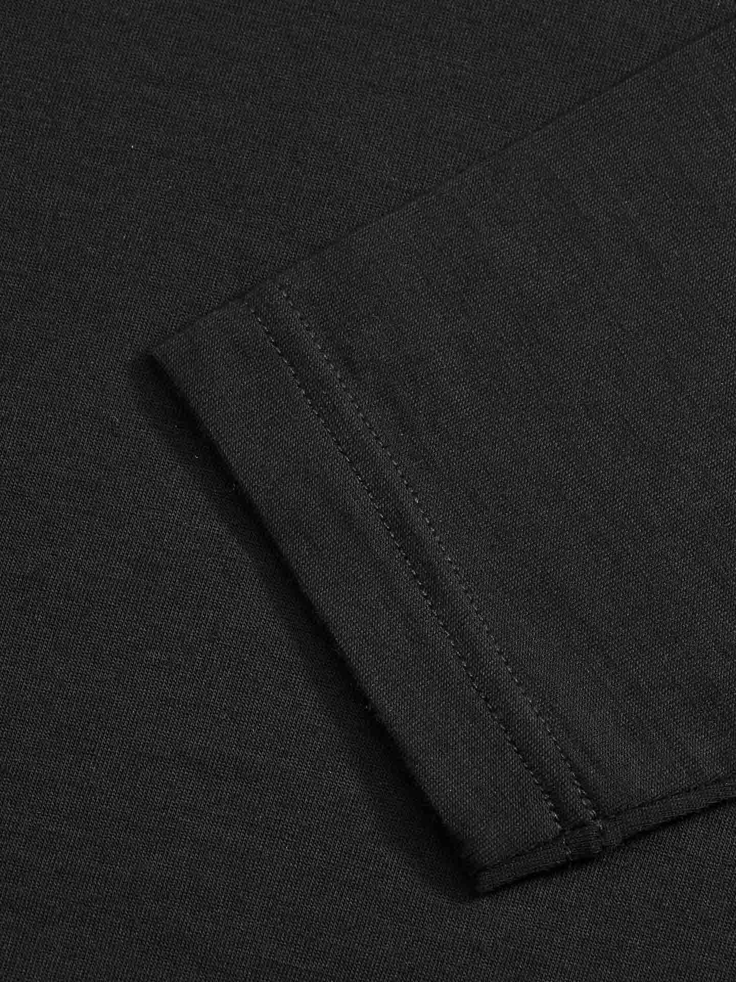 Close-up of the sleeve of a Sno Merino Long Sleeve Men by We Norwegians, highlighting breathable fabric and meticulous stitching. The smooth, soft material could easily rival merino wool.