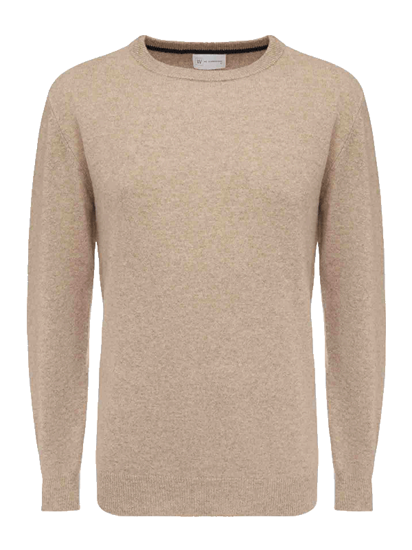 The Blefjell Cashmere Crewneck Men by We Norwegians is a beige, long-sleeved sweater crafted from pure cashmere yarn with a round neckline. The fabric is soft and slightly textured, featuring ribbed cuffs and a ribbed hem. This versatile luxury staple boasts a simple, classic design suitable for both casual and semi-formal wear.