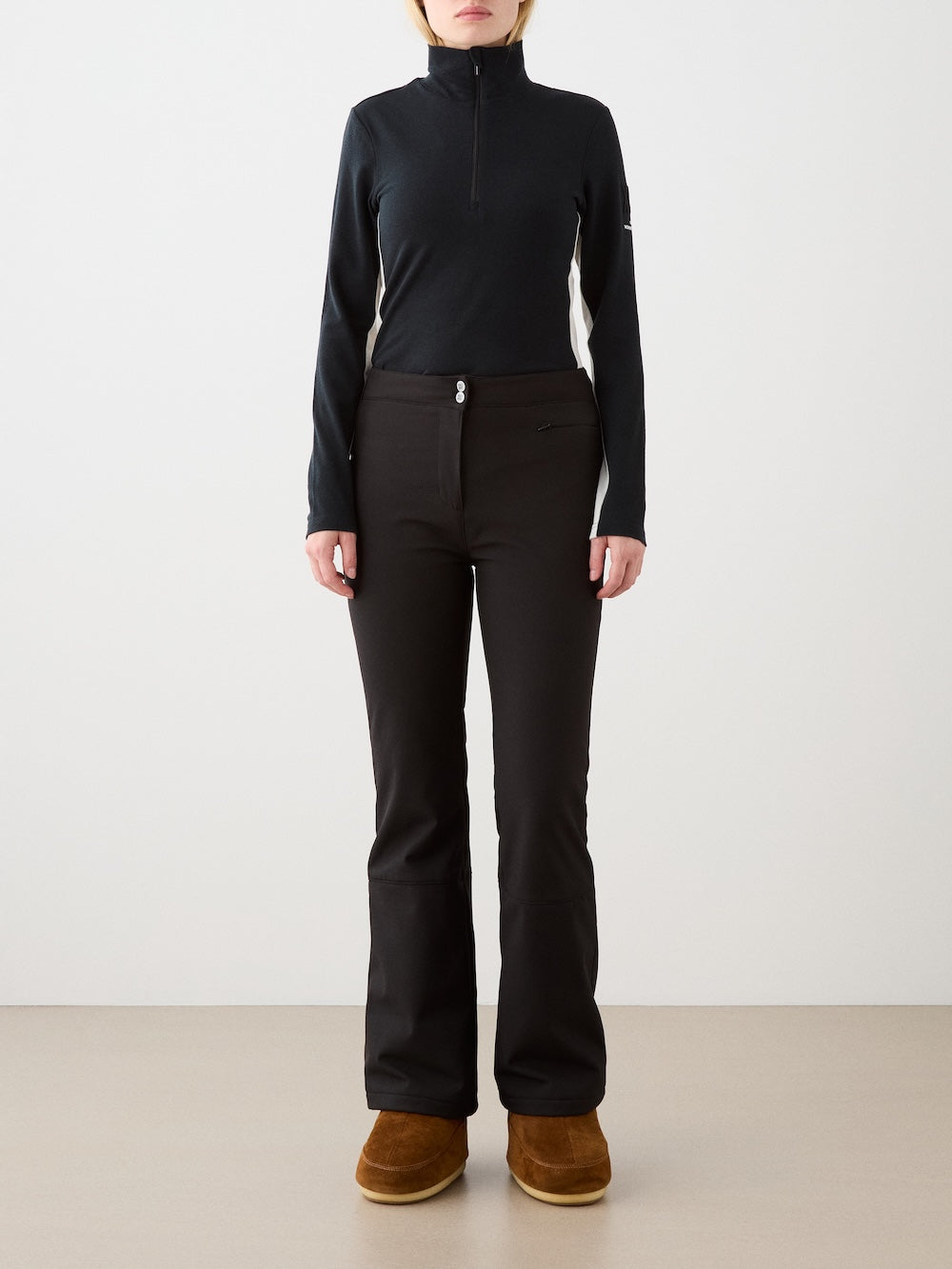 We Norwegians | FW25 | Womens Voss 1/4-Zip_Black | Model is wearing this light knit top with a stand collar, 1/4th zipper opening and long sleeves - paired with black pants on an off-white background | Front