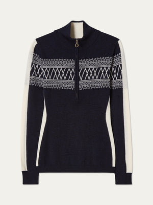 The We Norwegians Signature 1/4-Zip Women is a navy ski sweater with a white Setesdal pattern on the chest and sleeves, half-zip front, and white side panels.