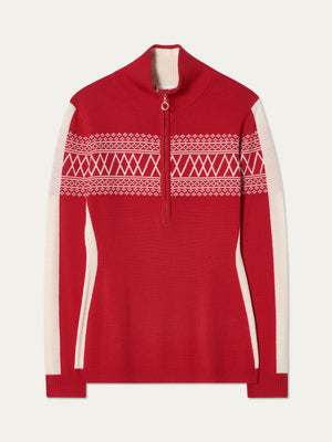The Signature 1/4-Zip Women by We Norwegians is a red ski sweater featuring a half-zip neckline, white Setesdal pattern on the chest and arms, and white side panels along the sleeves and torso.