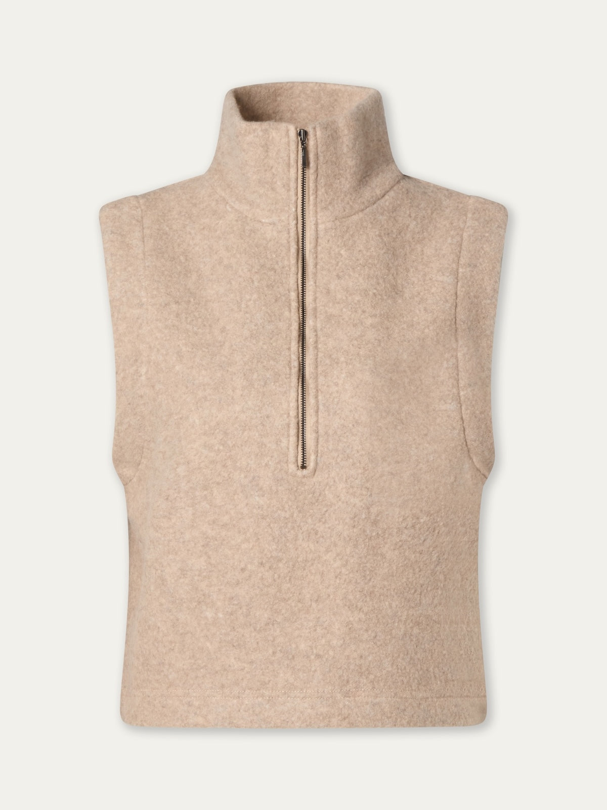 The We Norwegians Alta Vest Women is a sleeveless beige fleece vest featuring a high collar and half-zip front closure, crafted from soft felted merino for exceptional warmth and comfort—an ideal layering essential—shown against a plain white background.