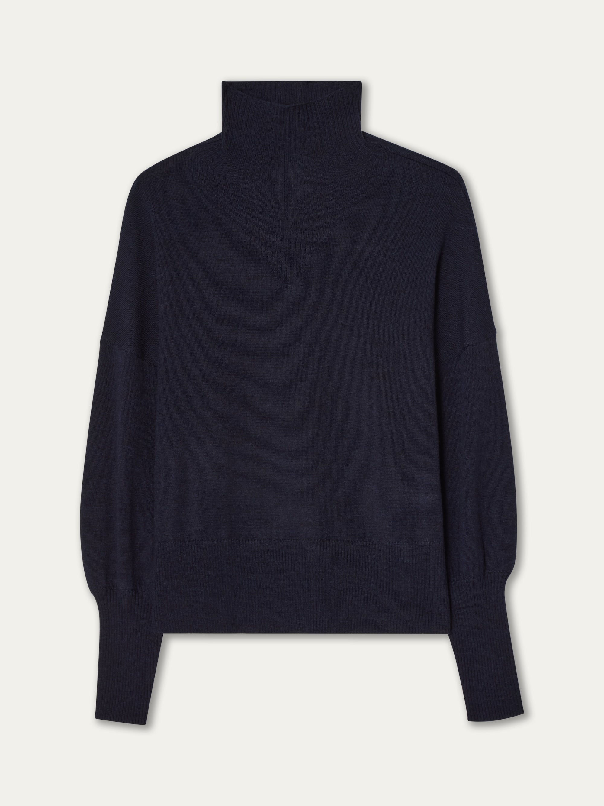 The Geilo Oversized Sweater Women by We Norwegians is a dark navy blue, long-sleeve turtleneck with an oversized fit, ribbed cuffs and hem, and crafted from lightweight knit, shown on a plain white background.