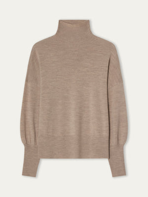 The Geilo Oversized Sweater Women by We Norwegians is a beige, long-sleeve merino wool knit with a relaxed fit and ribbed collar, cuffs, and hem, shown against a plain light background.