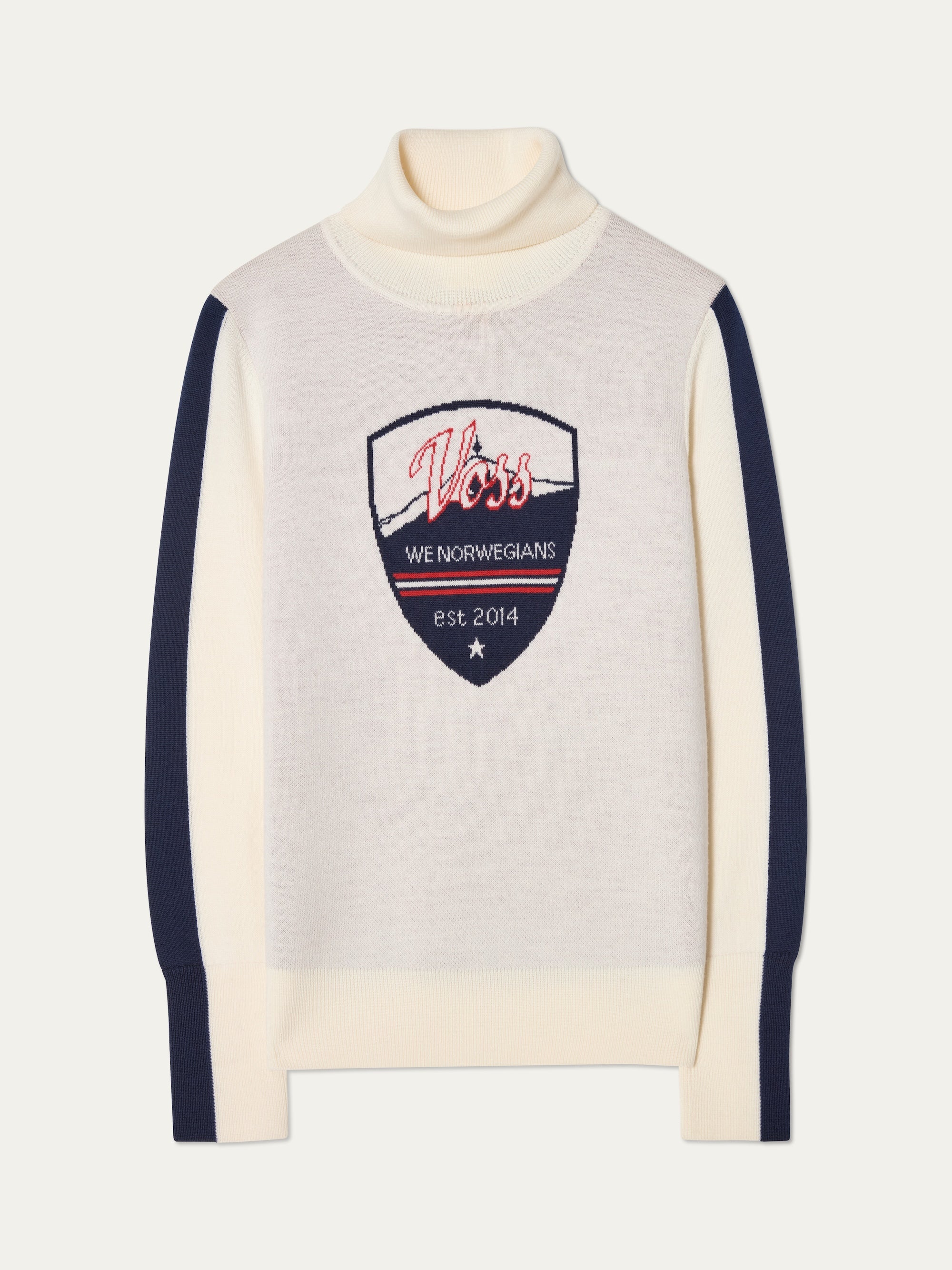 The We Norwegians Afterski Sweater Women is a cream merino wool turtleneck with navy sleeves and a bold shield patch, embroidered with "Voss," "WE NORWEGIANS," and "est. 2014" in red, white, and blue for a vintage ski vibe.