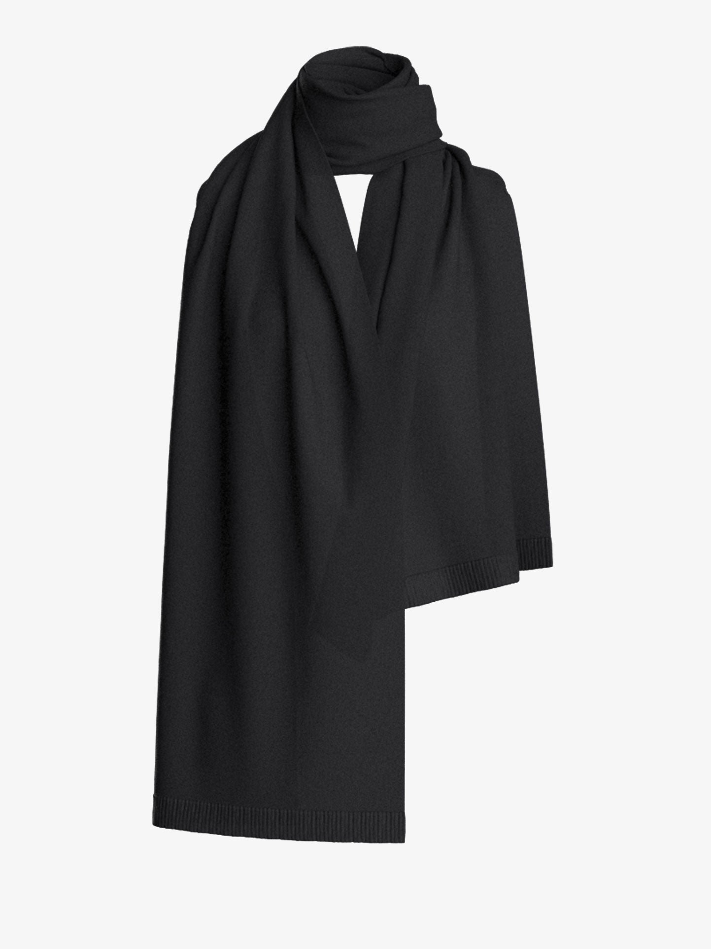 The Blefjell Cashmere Scarf by We Norwegians is elegantly folded and draped against a white backdrop, highlighting its luxurious black texture.