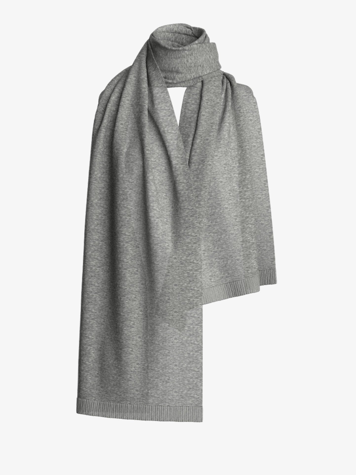 The Blefjell Cashmere Scarf by We Norwegians gracefully drapes with a soft, light gray hue and features a subtle ribbed texture along the edges, all set against a plain white background.