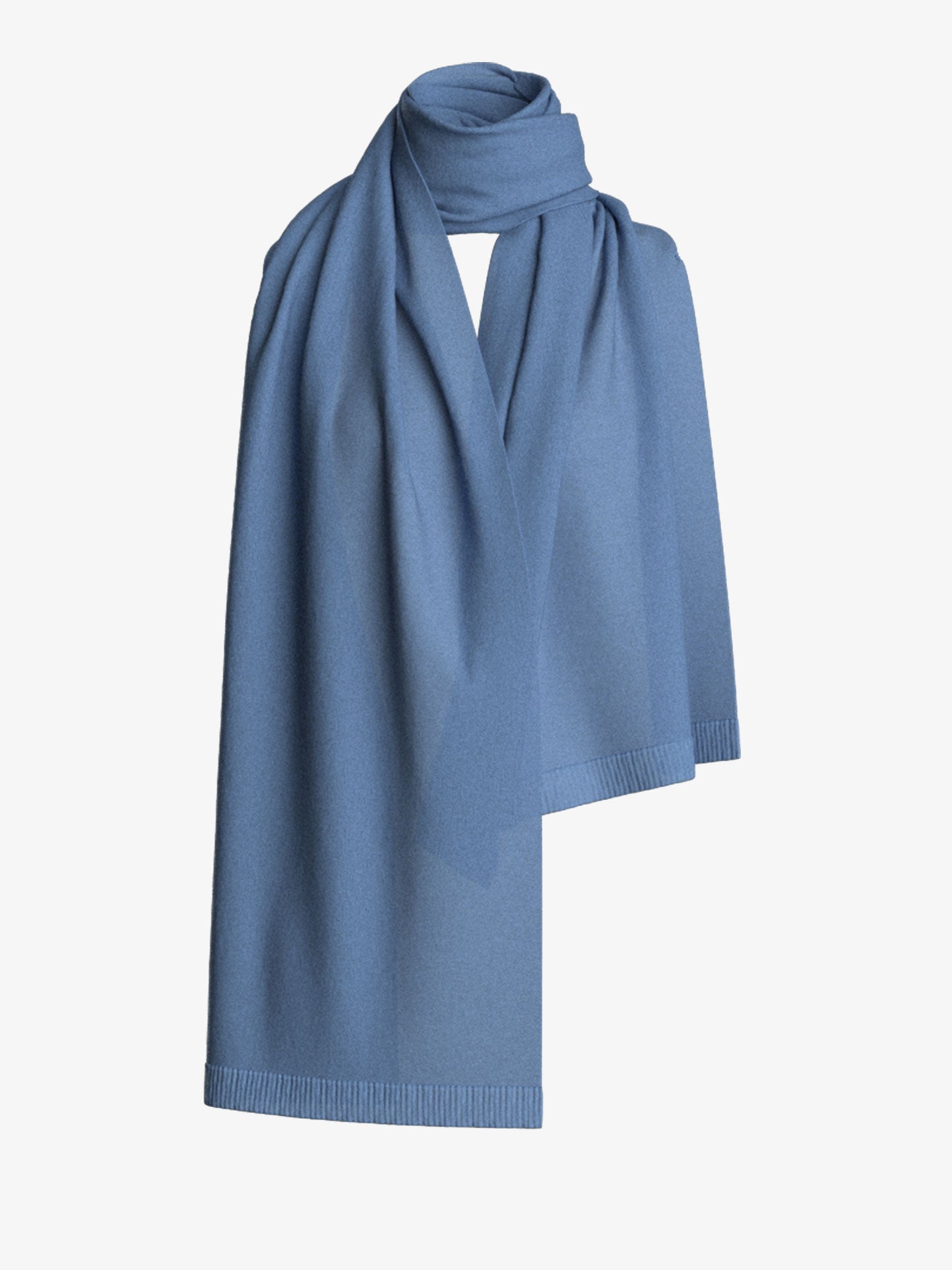 The Blefjell Scarf by We Norwegians, crafted from a soft blue fabric, is draped against a plain white background, with one end hanging down and the other wrapped artfully at the top.