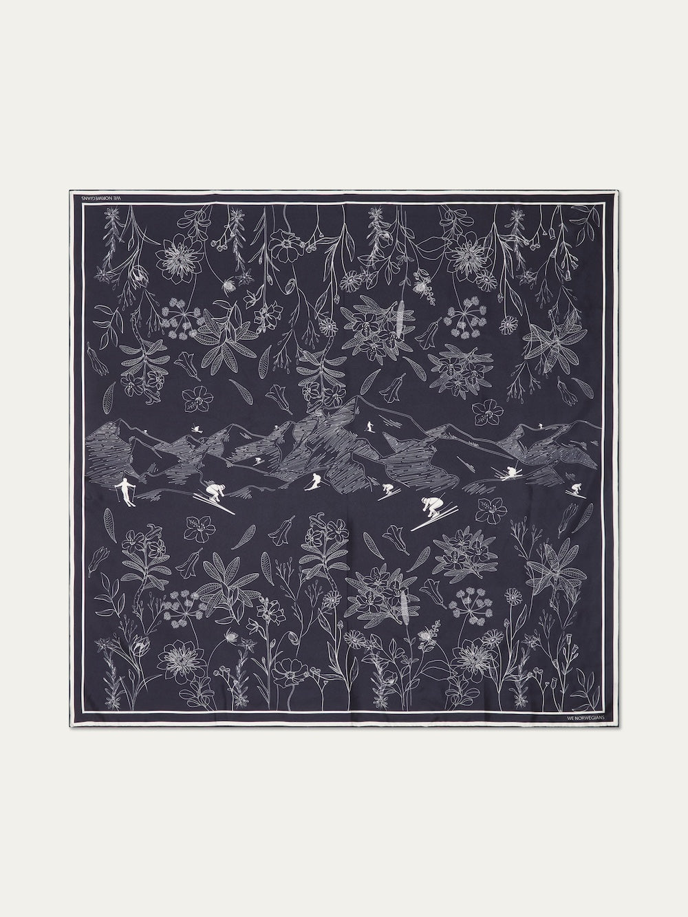 The Alps Silk Scarf by We Norwegians features a dark blue, Scandinavian-inspired design with white line art of mountains, birds, skiers, and alpine flora—an elegant accessory perfect for après-ski style.