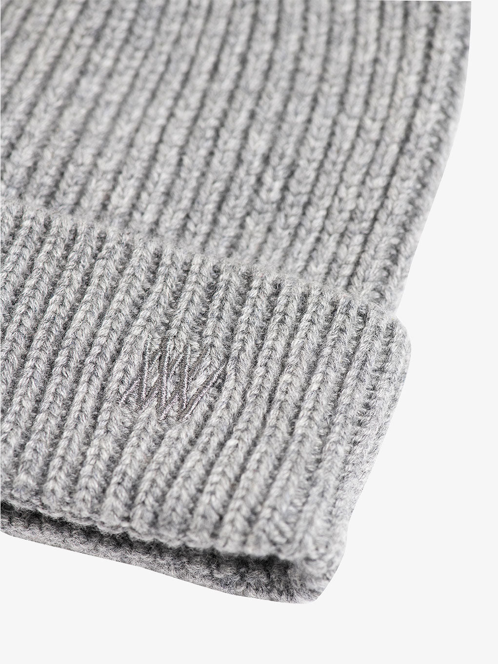 Close-up of the We Norwegians Blefjell Hat in gray, featuring tonal embroidery on the fold. The ribbed knit pattern is clearly visible, highlighting its warmth and casual style.