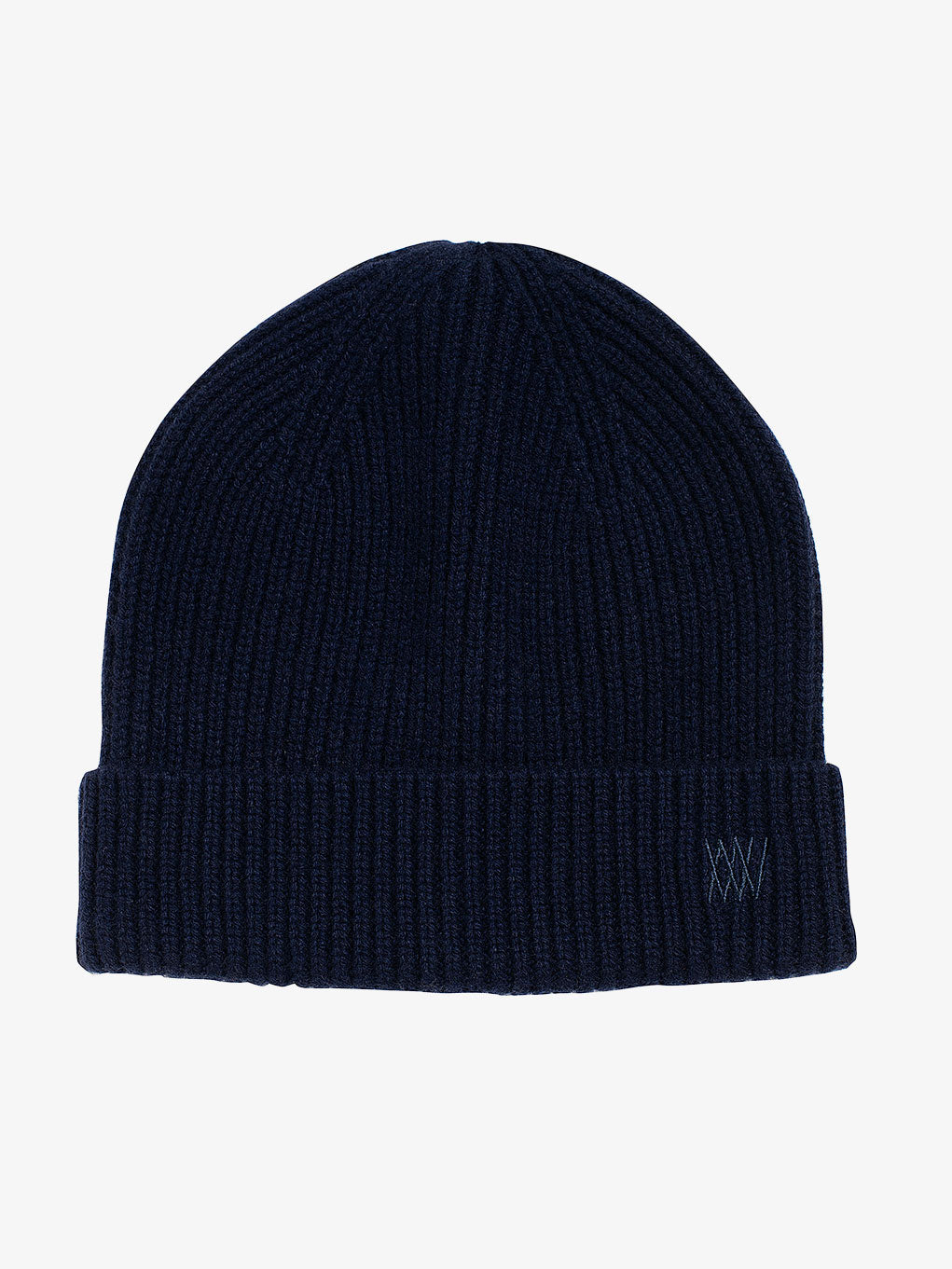 Introducing the Blefjell Hat from We Norwegians: a dark blue, ribbed knit beanie featuring an adjustable cuff and subtle tonal embroidery on the folded brim. The small logo enhances its elegance, making this cozy accessory a perfect addition to any wardrobe. Set against a plain white background, its timeless design effortlessly complements any style.