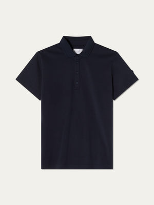 The We Norwegians Medalist Piqué Polo Women is a plain, short-sleeved, dark navy blue collared polo with a three-button placket, shown on a light background.