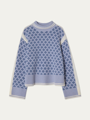 The We Norwegians Boat Sweater women - Pre Spring 26 features a lavender and blue geometric plus-sign pattern, cream shoulder and side accents, and ribbed cuffs, hem, and collar in a soft merino cashmere knit.
