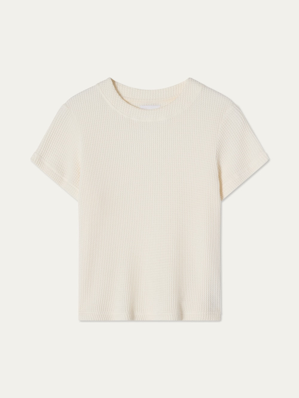 The We Norwegians Waffle Tee Women is a 100% cotton, off-white short-sleeve top with a crew neckline and casual waffle-knit design, shown against a white background.