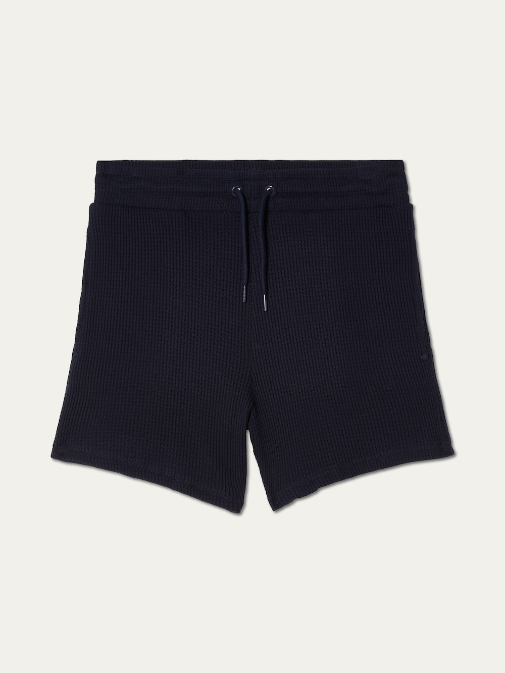 We Norwegians Waffle Shorts Women in dark navy blue cotton feature a textured knit, elasticated waistband with drawstring, and relaxed fit, shown flat on a white background.