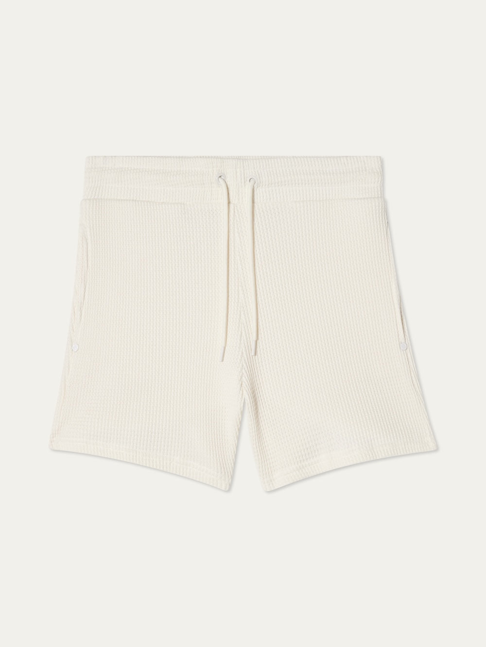 We Norwegians Waffle Shorts Women—off-white cotton shorts with elastic waistband, drawstring, and zippered side pockets, shown laid flat on a white background.