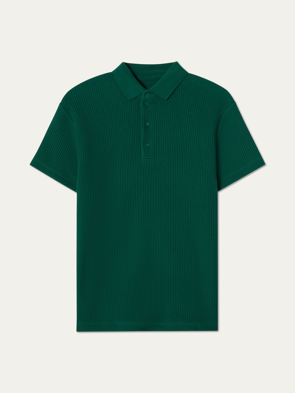 The We Norwegians Waffle Polo Men is a short-sleeve, dark green polo with textured waffle knit, a collar, and three-button placket, shown on a light background.