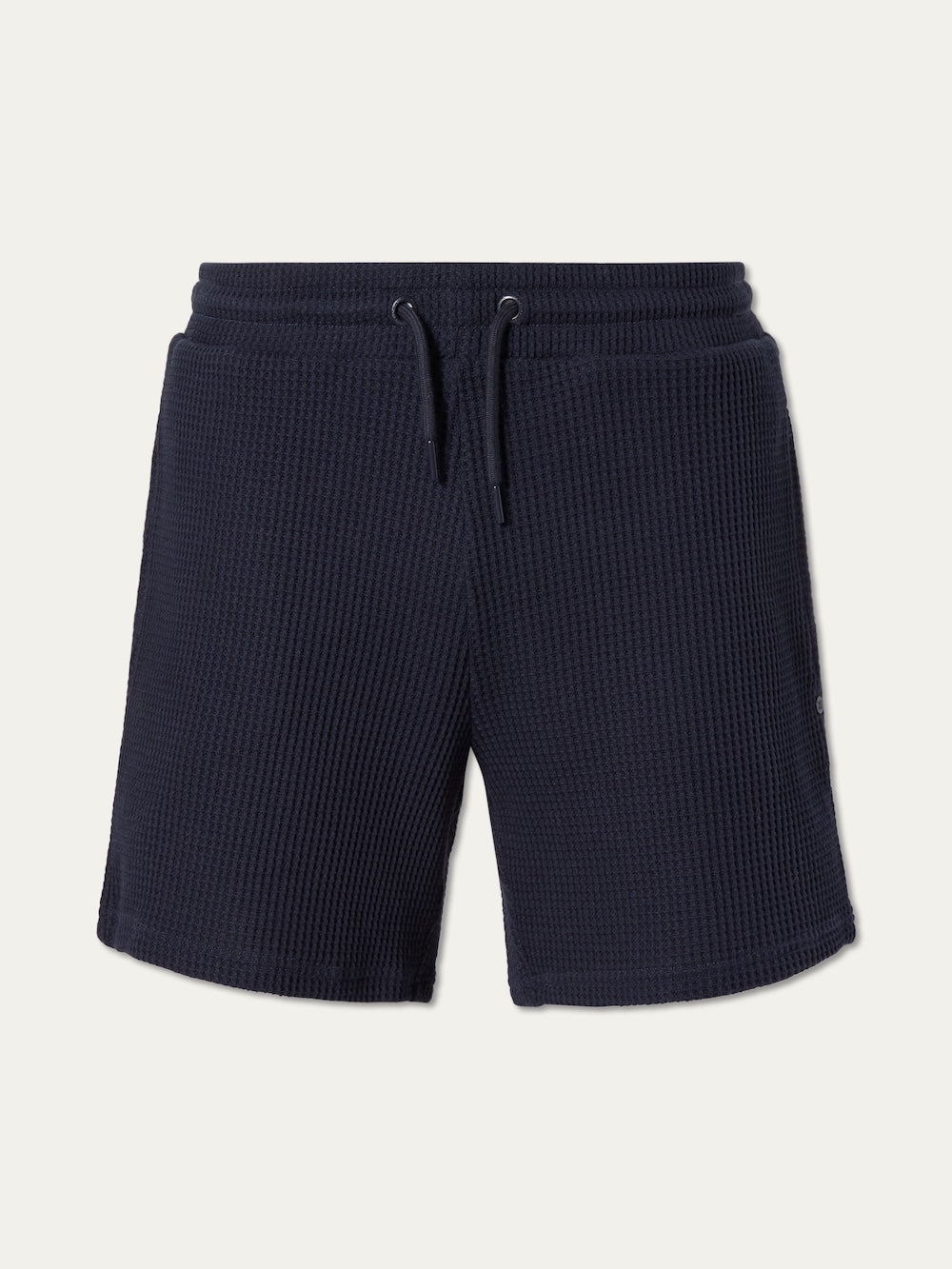 We Norwegians Waffle Shorts Men in navy blue cotton feature a relaxed fit, adjustable drawstring waistband, and side pockets, shown against a plain light background.