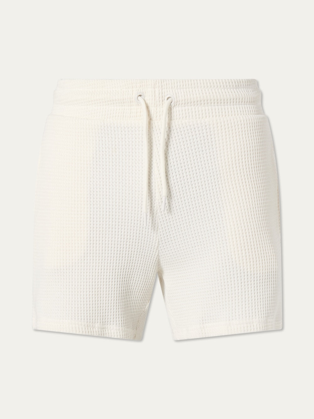 We Norwegians Waffle Shorts Men in off-white cotton feature a relaxed fit, elastic waistband, and front drawstring tie, shown on a plain light background.