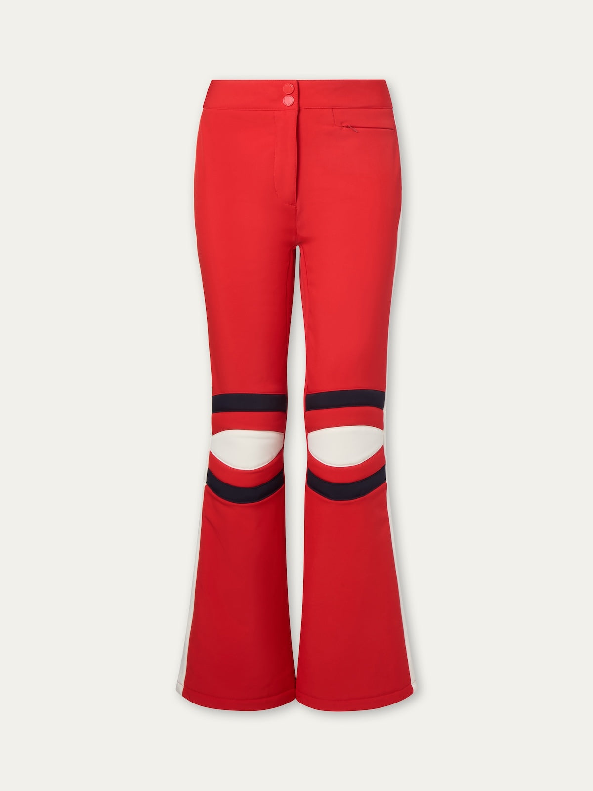 The Solo Ski Pant for women by We Norwegians features red flare legs, two black-striped cutout panels above the knees, a fitted waist, front zipper, and button closure for a bold, sporty look inspired by retro ski pants.