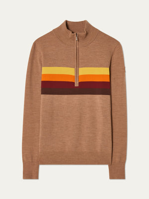 The We Norwegians FreeBird ZipUp women’s sweater is light brown merino wool with a half-zip, stand-up collar, ribbed cuffs and hem, and horizontal yellow, orange, red, and brown chest stripes.