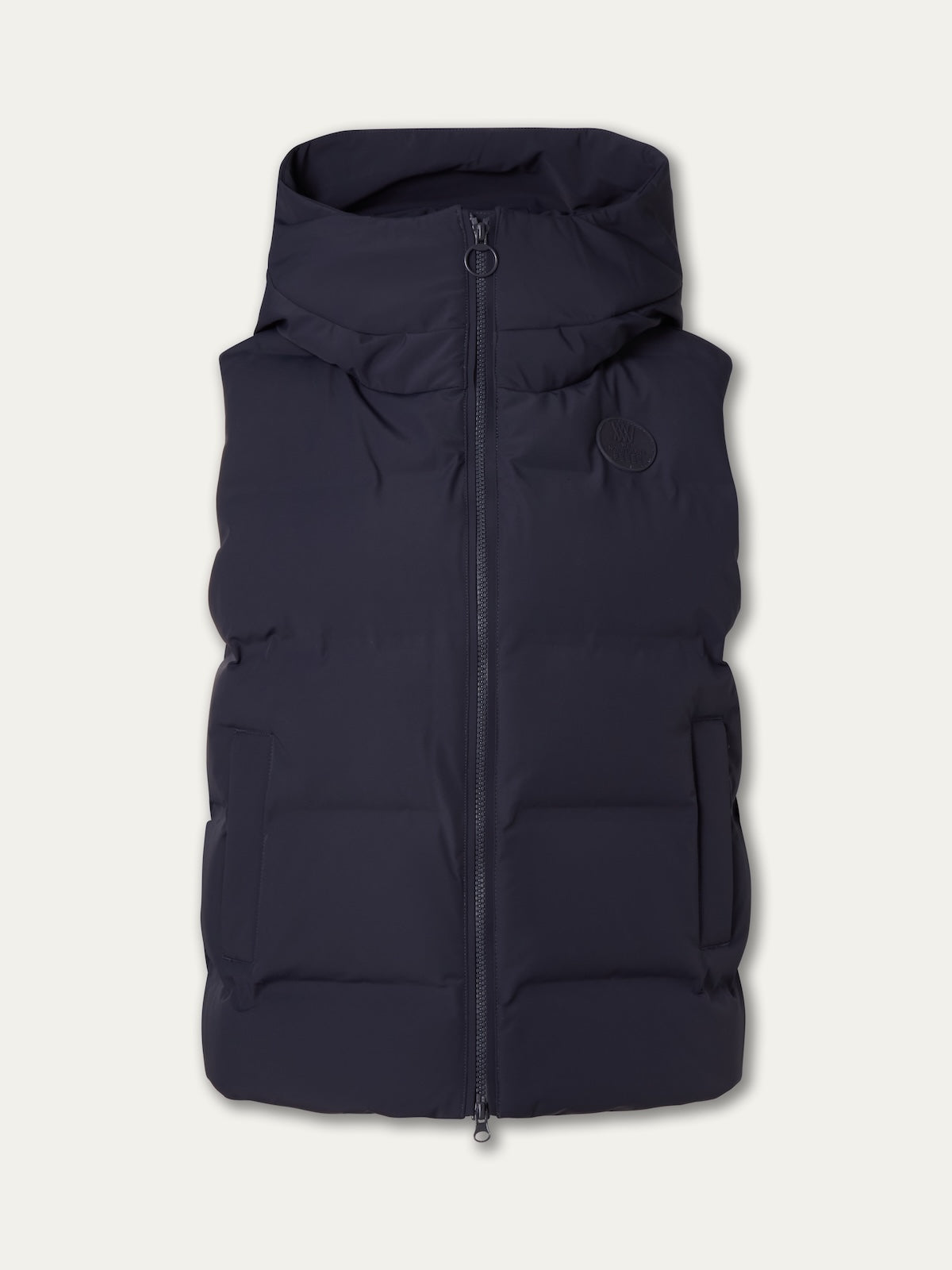 The We Norwegians Aurora Vest women is a sleeveless dark navy puffer with a hood, front zipper, and two side pockets, displayed on an off-white background for a refined Scandinavian look.