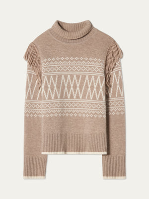 The We Norwegians Setesdal Sweater women features beige and white knit, a turtleneck, geometric diamond patterns, ribbed hem and cuffs, plus shoulder fringe inspired by traditional Norwegian style.