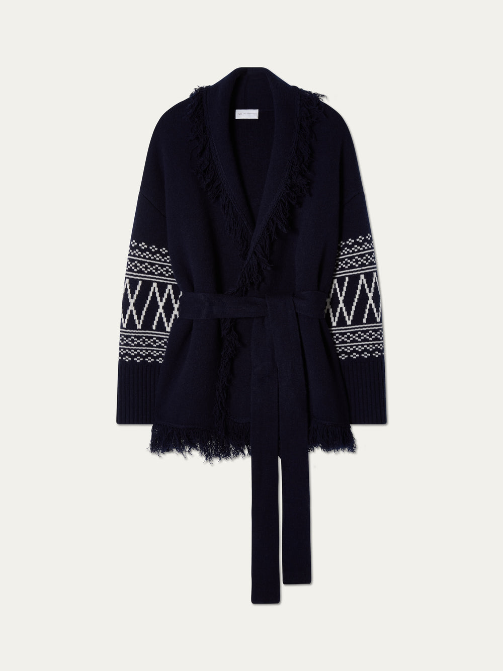 The We Norwegians Setesdal Cardigan women features a navy blue merino-cashmere blend, belted waist, fringe trim, and white geometric sleeve patterns, shown on a plain light background.