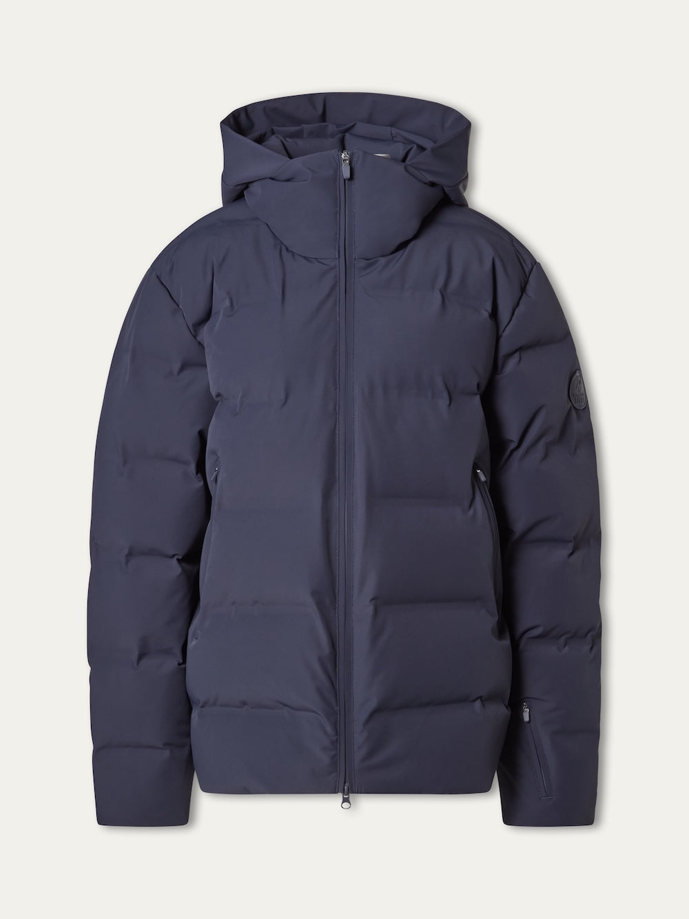 The Nordlys Ski Jacket men by We Norwegians is a navy blue, hooded puffer with responsible down, front zipper, two side pockets, and quilted design—ideal for skiing. Shown against an off-white background.