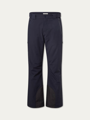 The Hammerfest Ski Pant men by We Norwegians are navy blue, featuring belt loops, button and zip closure, front zipper pockets, and reinforced black fabric at the inner ankles. Displayed against a plain white background.