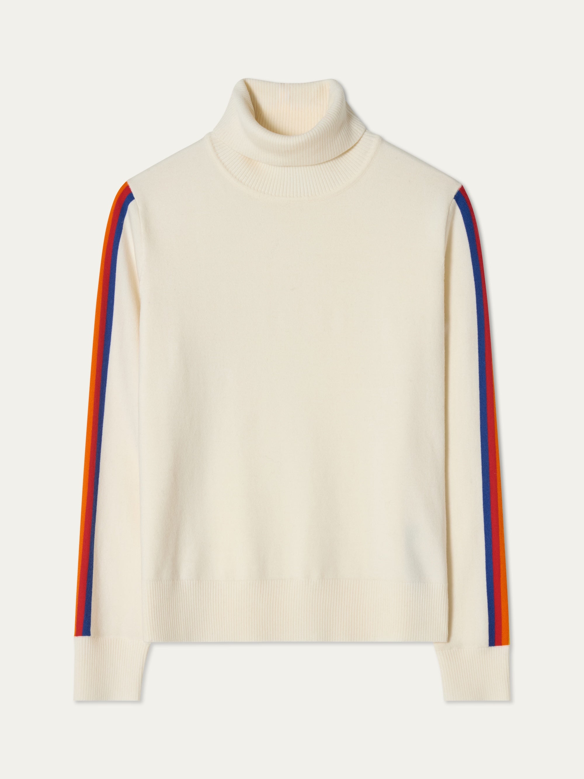 The FreeBird TurtleNeck Women by We Norwegians is a cream merino wool sweater with bold red, orange, and blue stripes down each sleeve—a cozy nod to classic ski style.