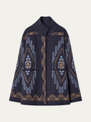 The We Norwegians Kautokeino Jacket for women is a navy boiled wool piece with a high collar and geometric jacquard pattern in light blue, beige, and brown, featuring symmetrical designs on the front, sleeves, and hem.