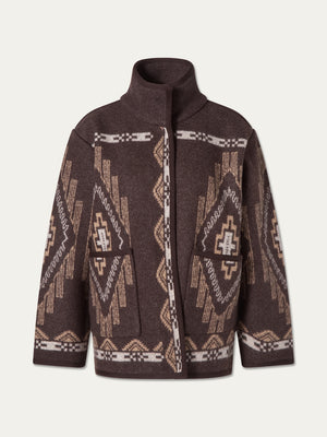 We Norwegians Pioneer Jacket women: an oversized dark brown boiled wool jacket with a high collar, tan and cream geometric pattern, and two front patch pockets.