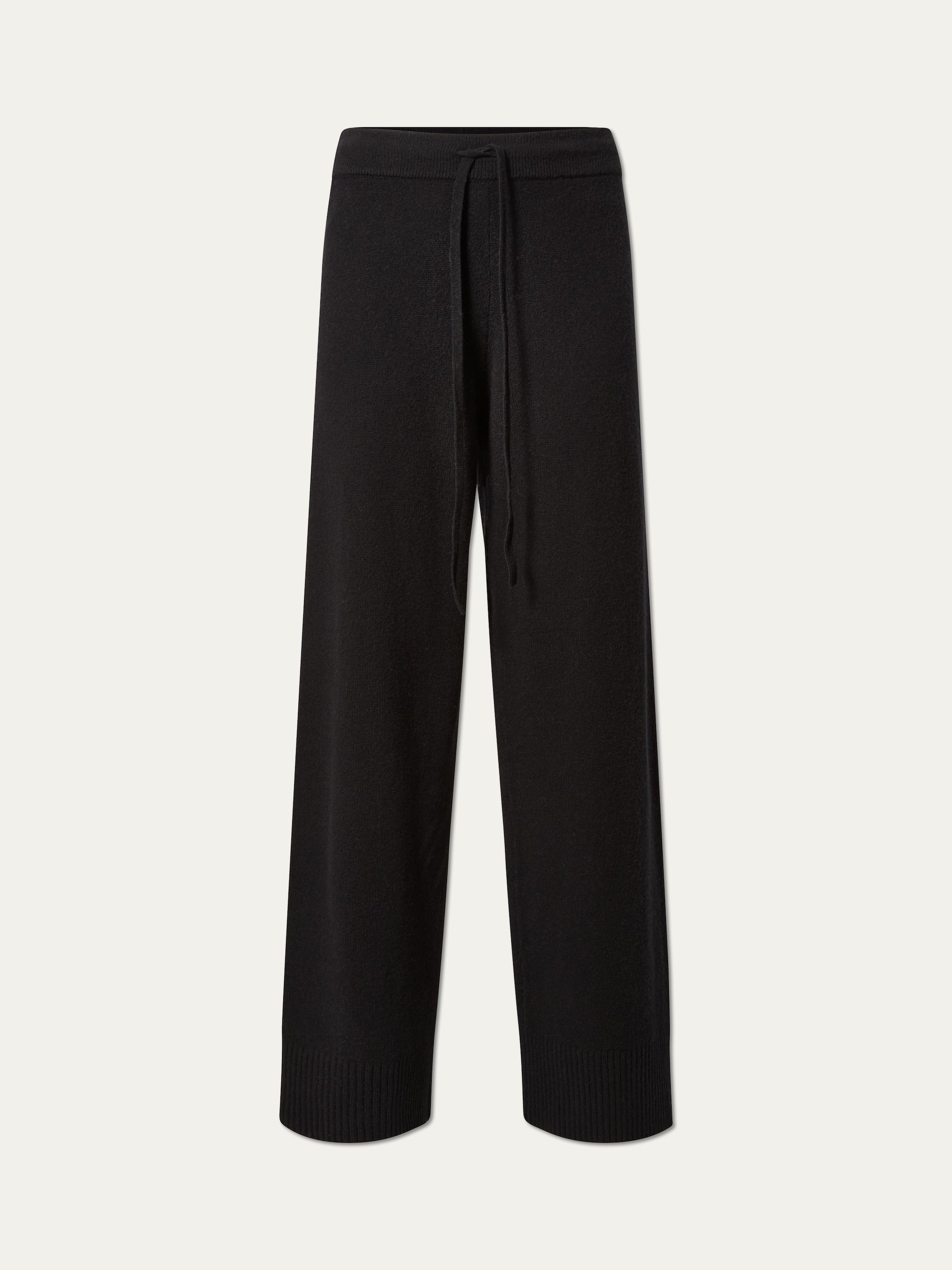 The Geilo Jogger women by We Norwegians features a relaxed fit, elastic waistband with drawstring, and ribbed ankle cuffs. These cozy knit pants are shown against a plain white background.