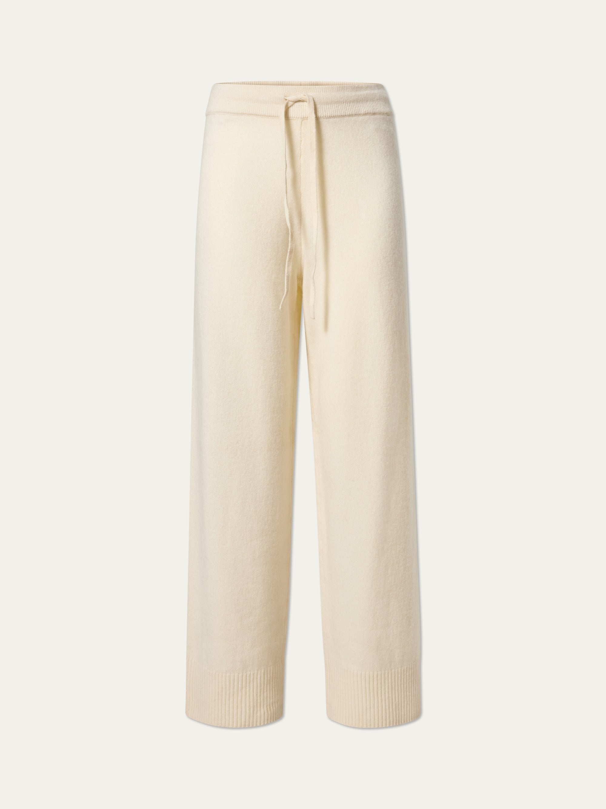 The Geilo Jogger women by We Norwegians features cream-colored, cozy knit fabric with wide legs, a drawstring waist, and ribbed cuffs, showcased against a plain white background.