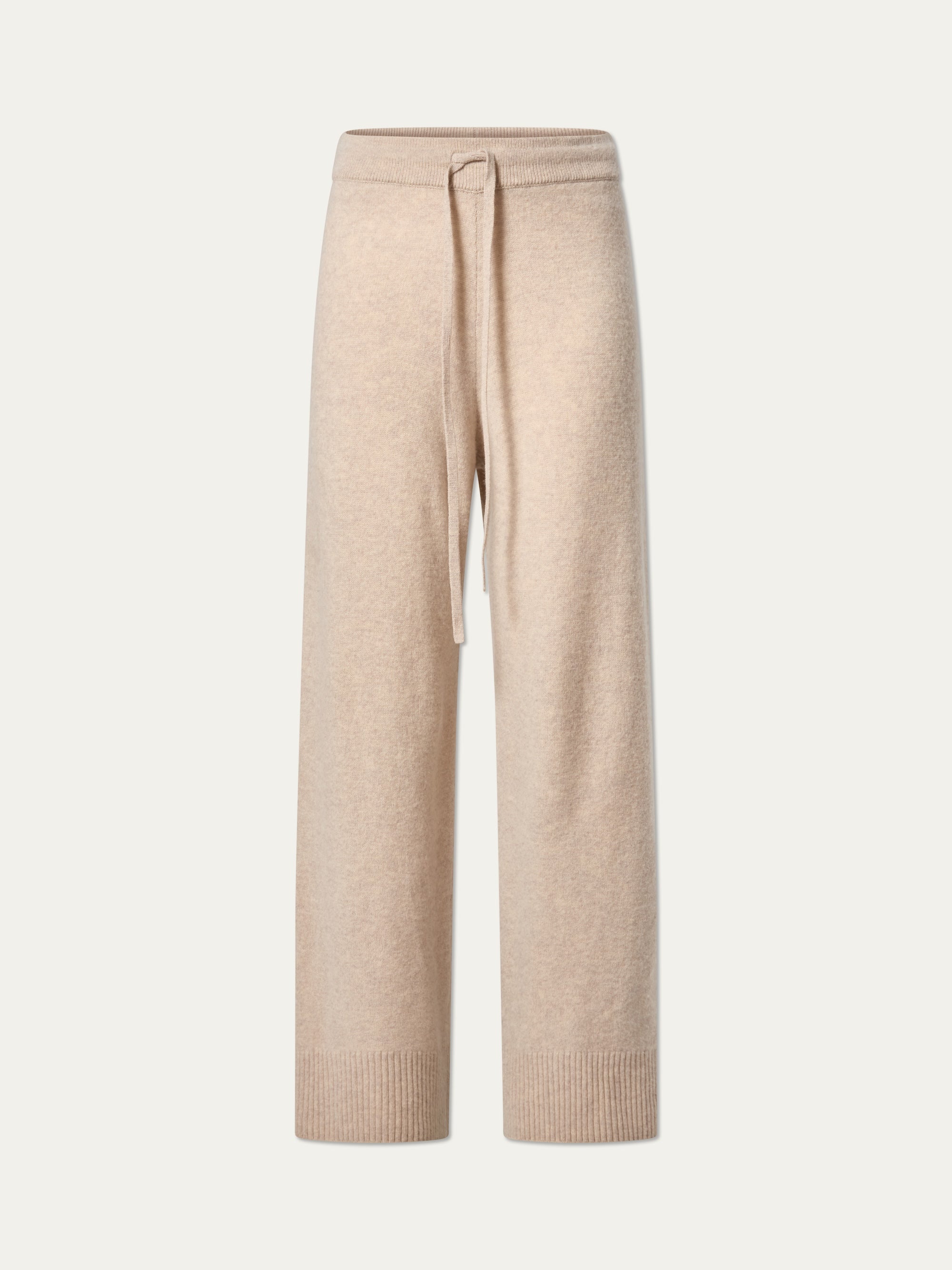 The We Norwegians Geilo Jogger women’s pants feature a beige cozy knit, drawstring waist, ribbed cuffs, and relaxed fit jogger style, shown on a plain light background.
